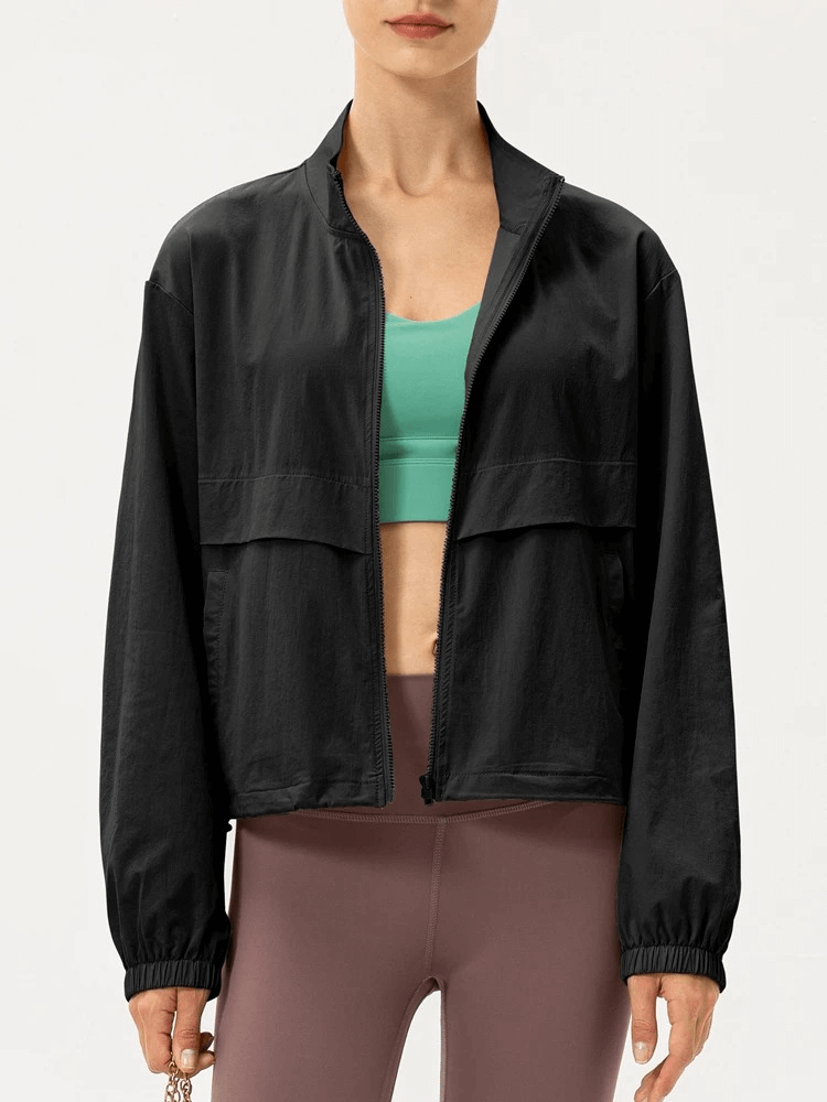 Women's black UV protection windbreaker for running, lightweight and breathable, nylon and spandex blend, perfect for outdoor sports.